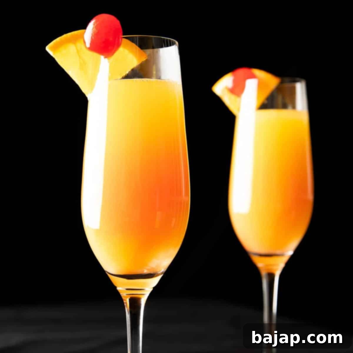 Beautiful layered sunrise mimosa cocktail, tart and spritzy with a delicious cherry sweetness, perfectly mimicking a radiant dawn.