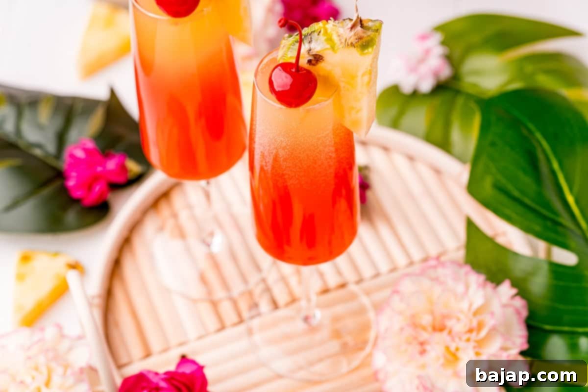 A light, sweet, and fruity Hawaiian Mimosa, a viral TikTok recipe made with prosecco, coconut rum, pineapple juice, and grenadine.