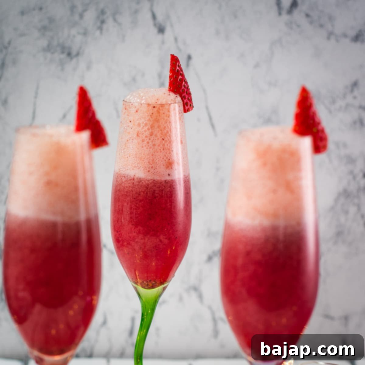 Gorgeous colored champagne flutes filled with vibrant berry mimosas, a perfect and easy Mother's Day drink.