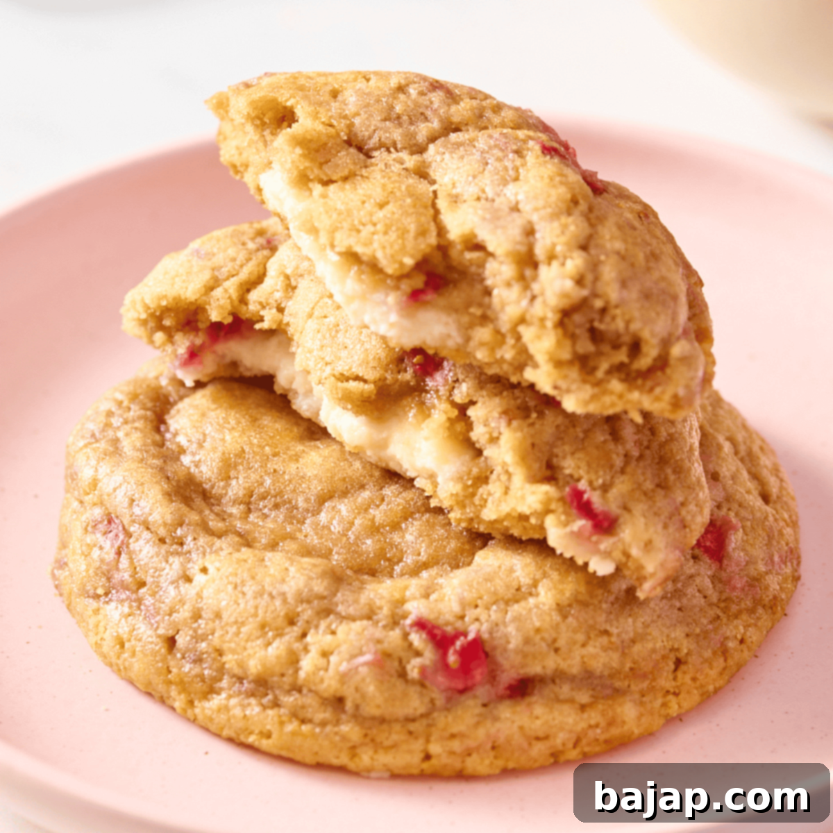 Sweet and fruity Stuffed Strawberry Cheesecake Cookies with a creamy center and crisp, golden edges.