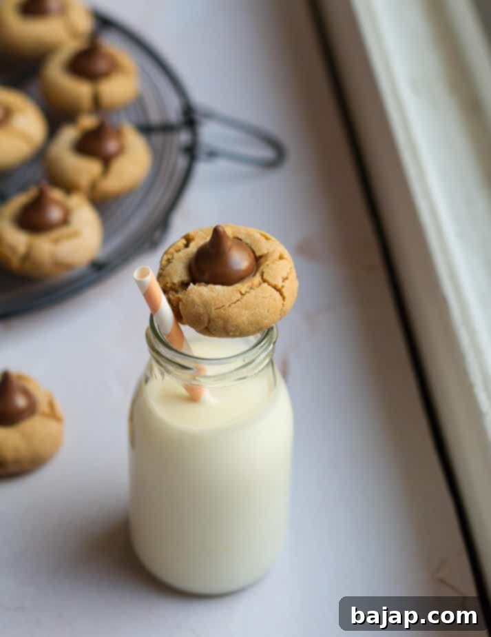 Classic, soft Peanut Butter Blossom Cookies topped with a chocolate kiss.