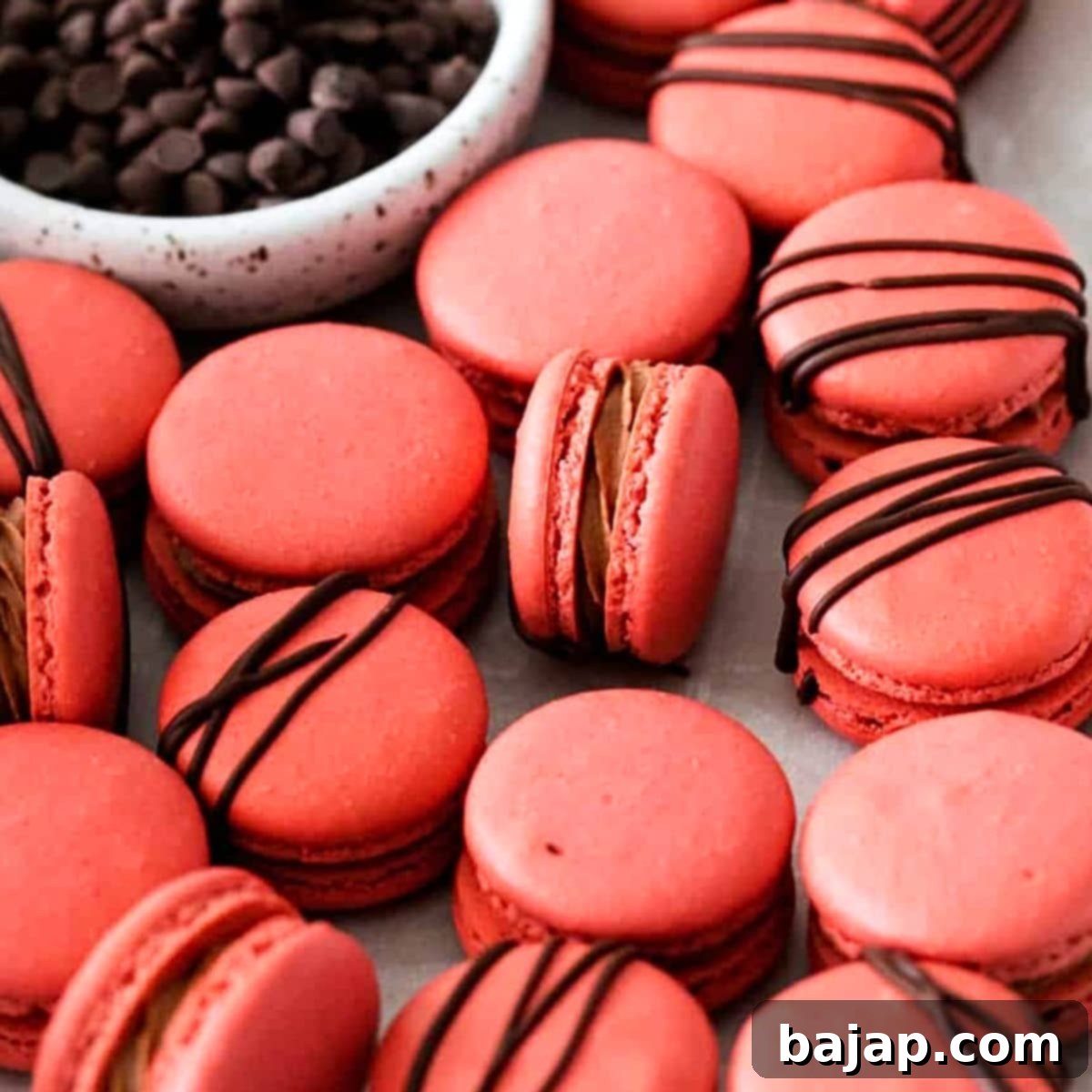 Exquisite Cherry Macarons filled with chocolate buttercream and cherry jam, gluten-free and dairy-free.