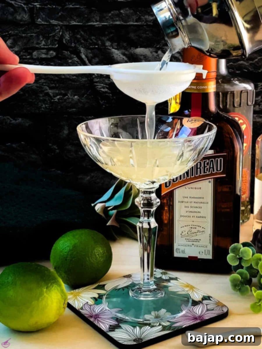 Fine strain the Margarita into the serving glass to remove any small pieces of ice. This gives the cocktail its silky texture.