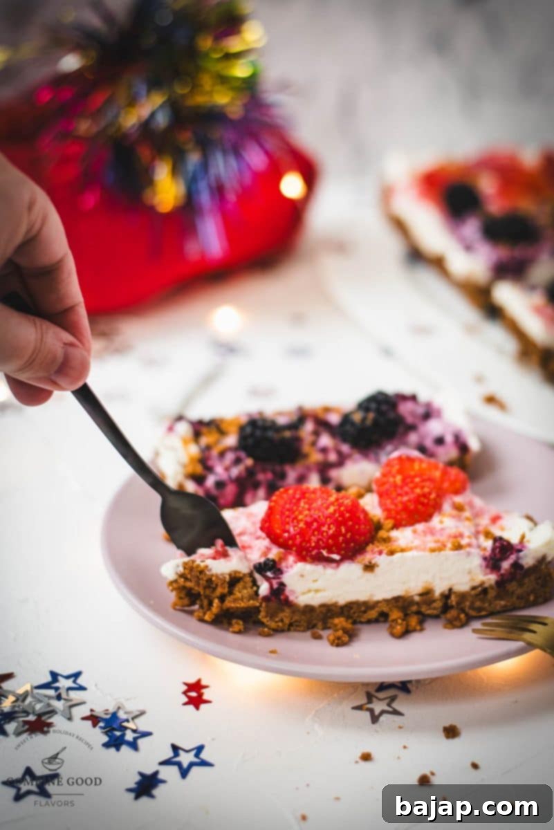 Delicious individual slices of no-bake 4th of July fruit tart, with a Biscoff crust, creamy filling, and fresh berries, ready to be enjoyed.