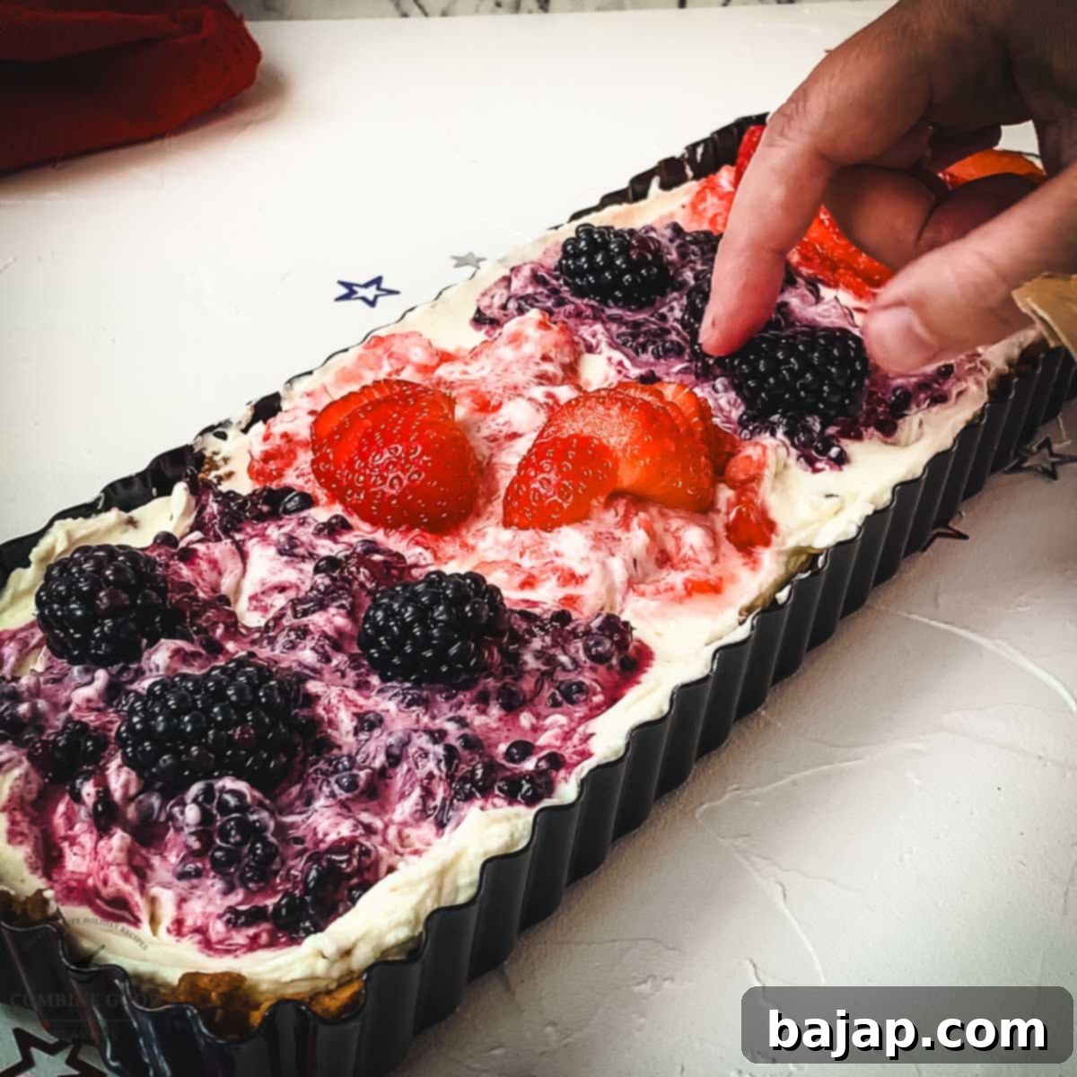Arrange fresh blackberries and strawberries artfully on top of the tart for vibrant color and fresh flavor.