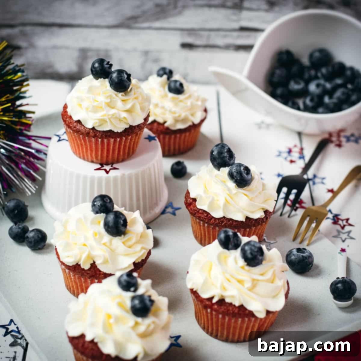 Gorgeous red, white and blue cupcakes, placed on white plate.