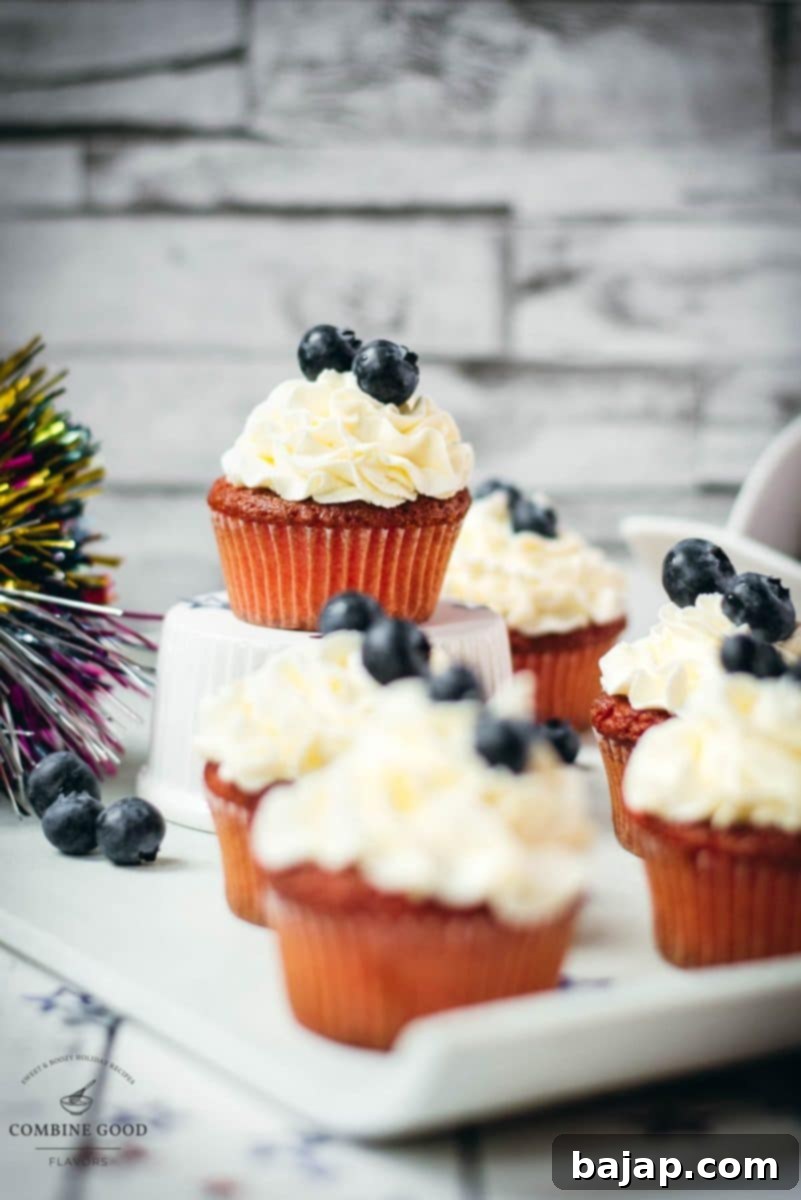 Gorgeous red, white and blue cupcakes, perfectly arranged on a white plate, ready for a festive celebration.