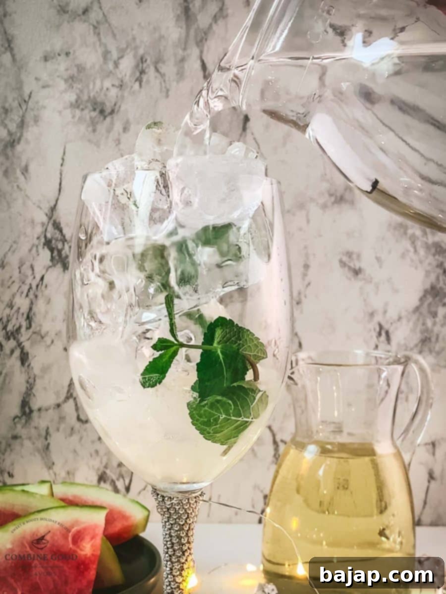 Adding sparkling mineral water to the wine glass.