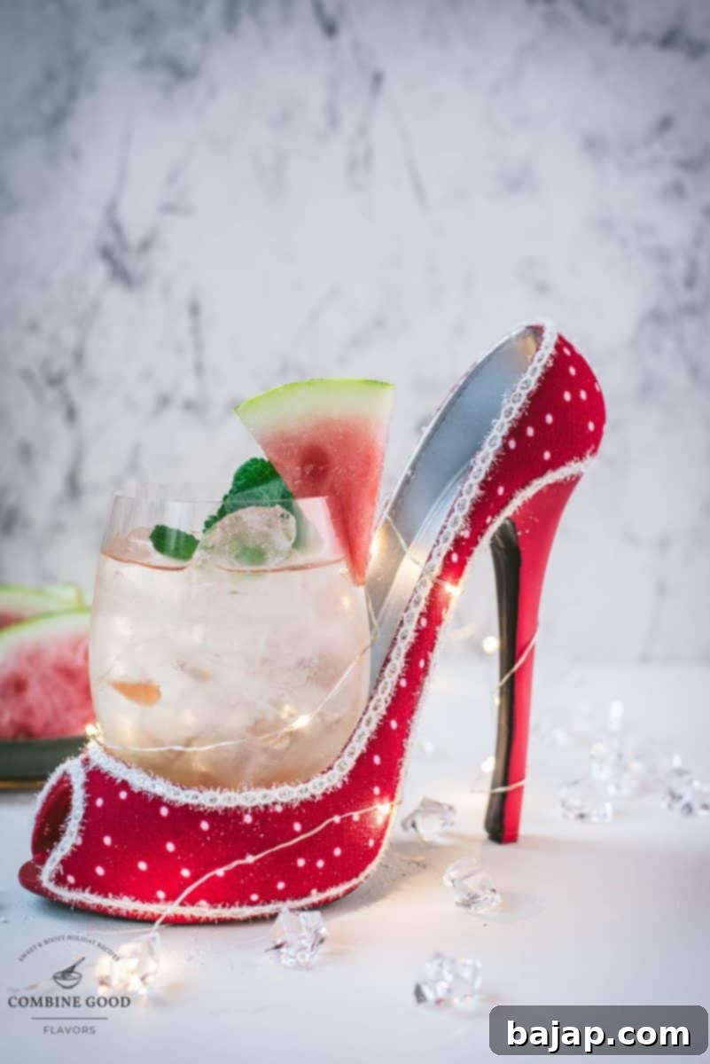 Delicious watermelon spritz with Prosecco placed in a red and white spotted high heel.