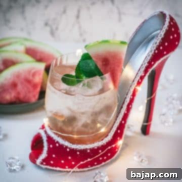 Delicious watermelon spritz with Prosecco placed in a red and white spotted high heel.