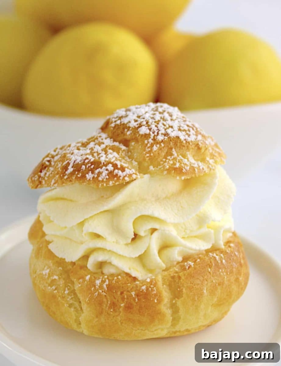 Elegant lemon cream puffs dusted with powdered sugar.