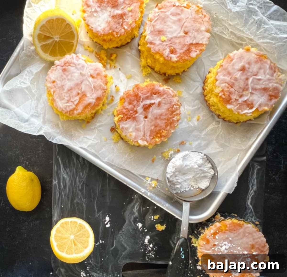 A slice of lemon poke cake with glaze and lemon zest.