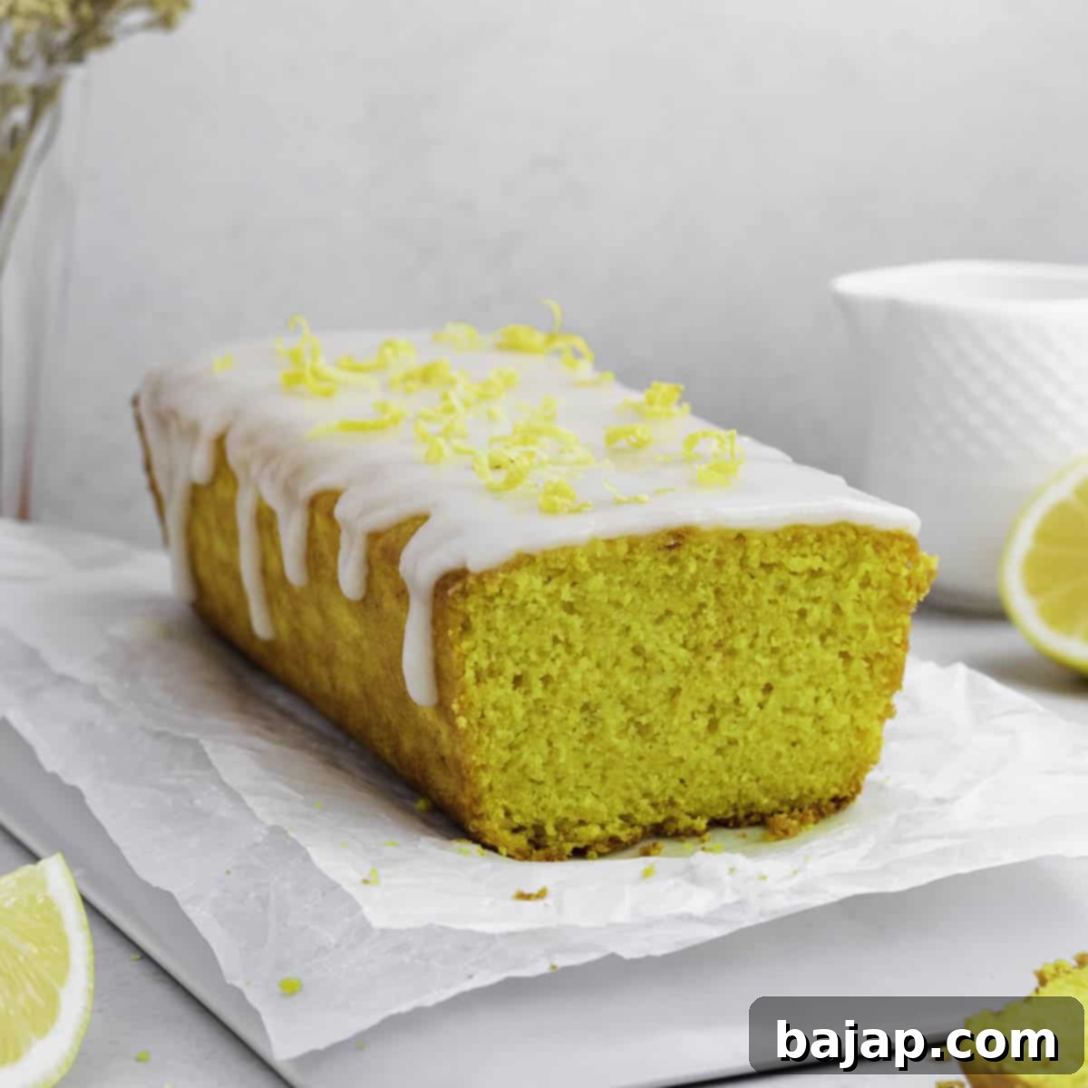 Golden lemon turmeric tea cake with a slice removed.