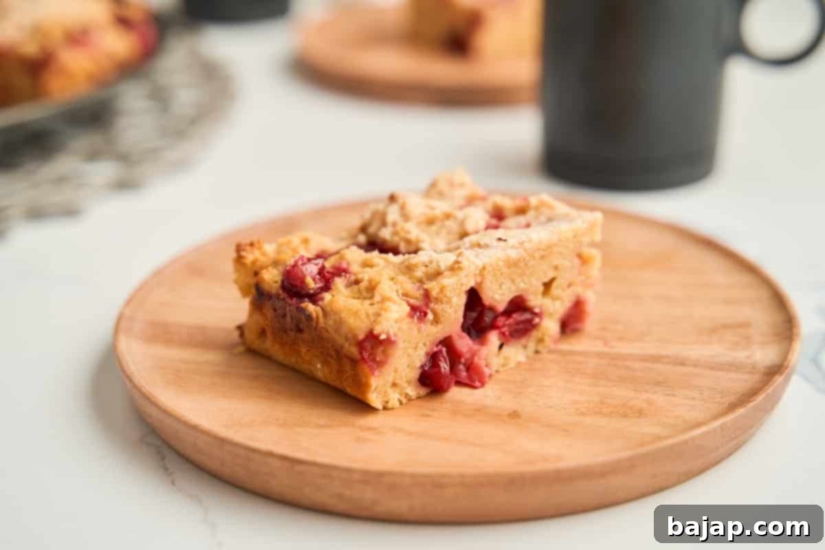 Tart and sweet cranberry lemon bars on a wooden board.