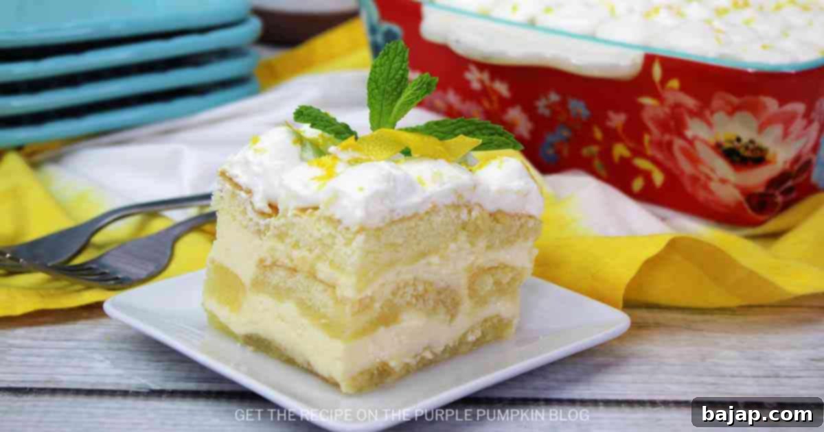 Elegant Limoncello Tiramisu in a glass dish with lemon slices.