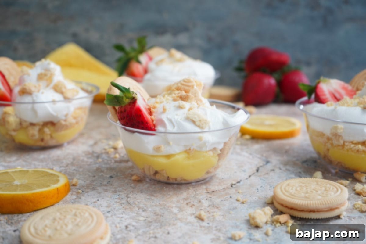 Layered lemon cookie parfaits in glass cups.