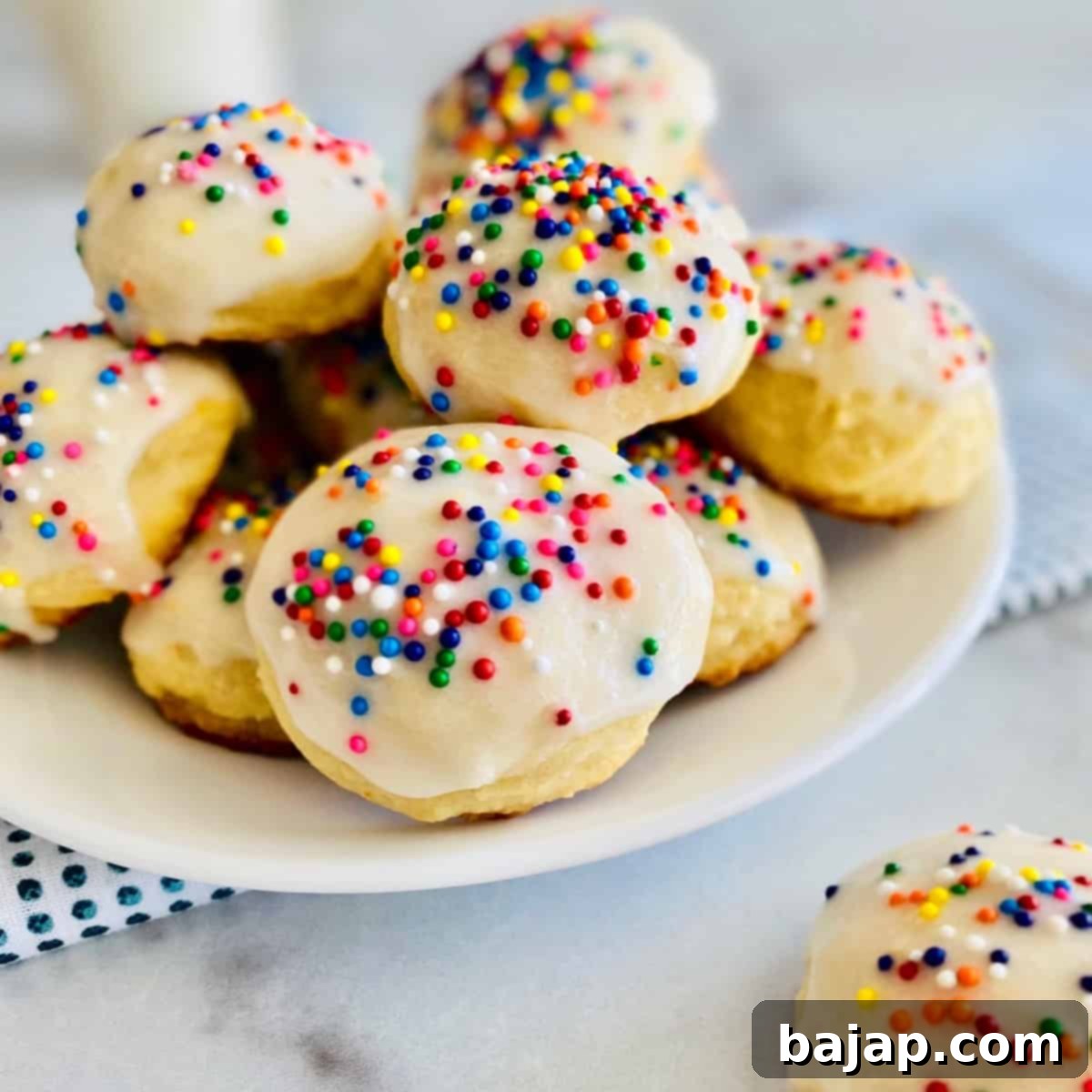 Soft Italian Lemon Ricotta Cookies, frosted and sprinkled.