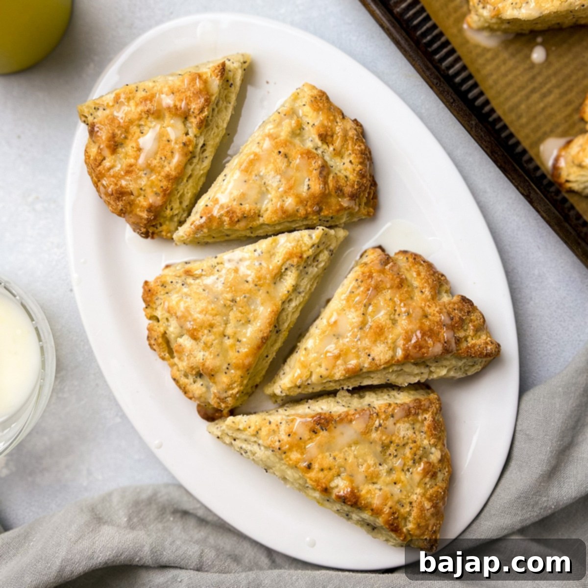Golden brown lemon poppyseed scones with a lemon glaze.