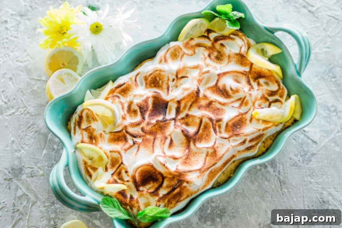 Delicious lemon tres leches cake slice in a blue pan.