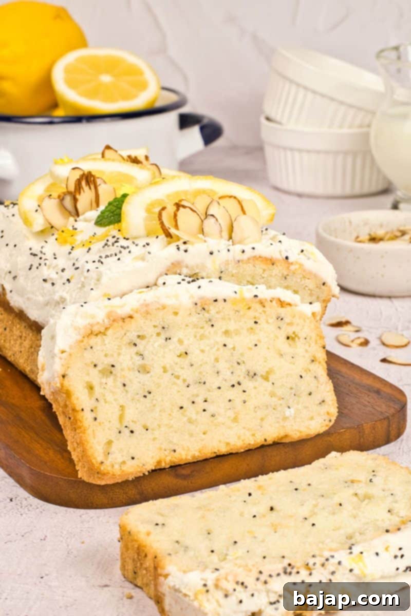 A slice of fluffy vegan lemon poppy seed cake with glaze.