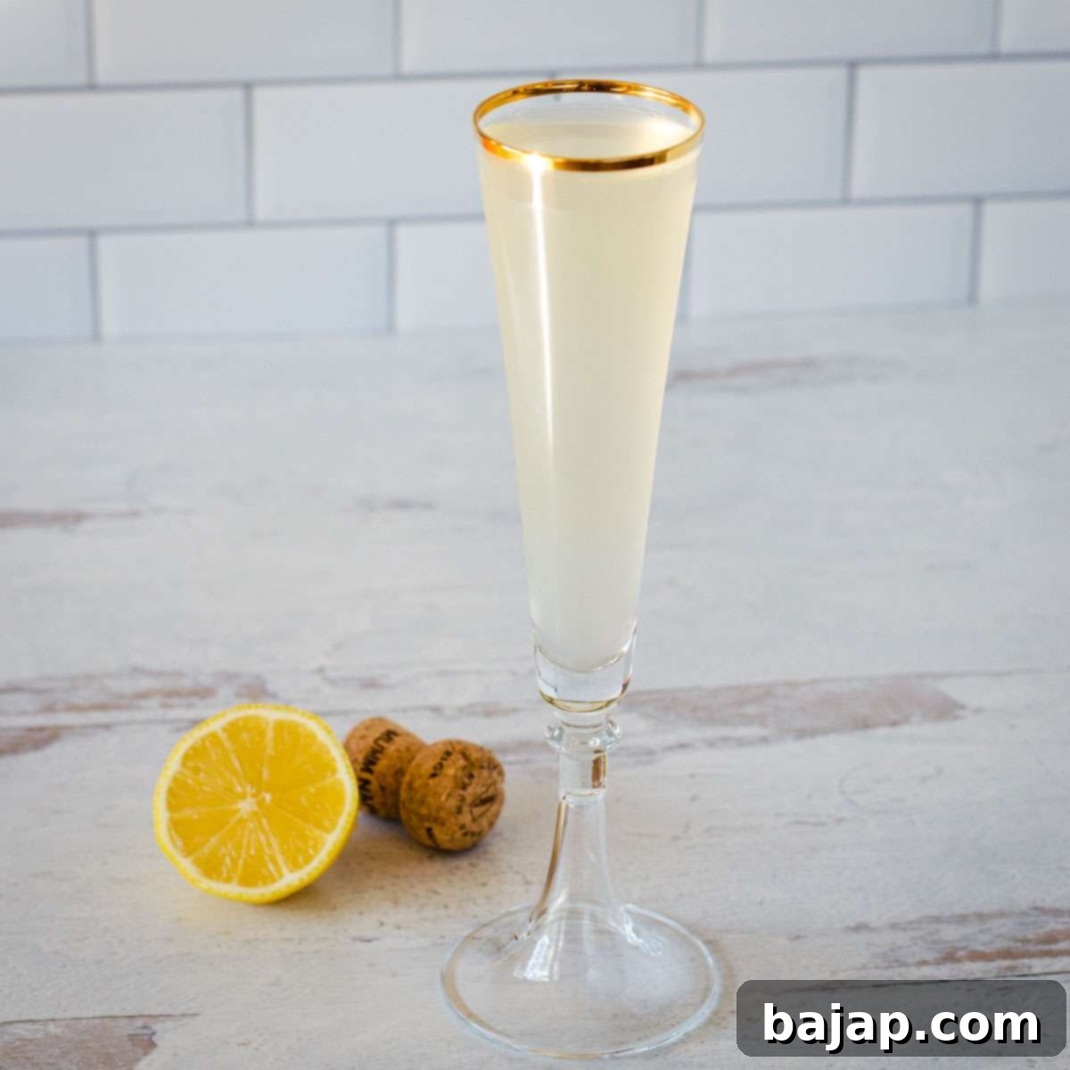 Elegant French 76 cocktail with a lemon twist, perfect for celebrations.