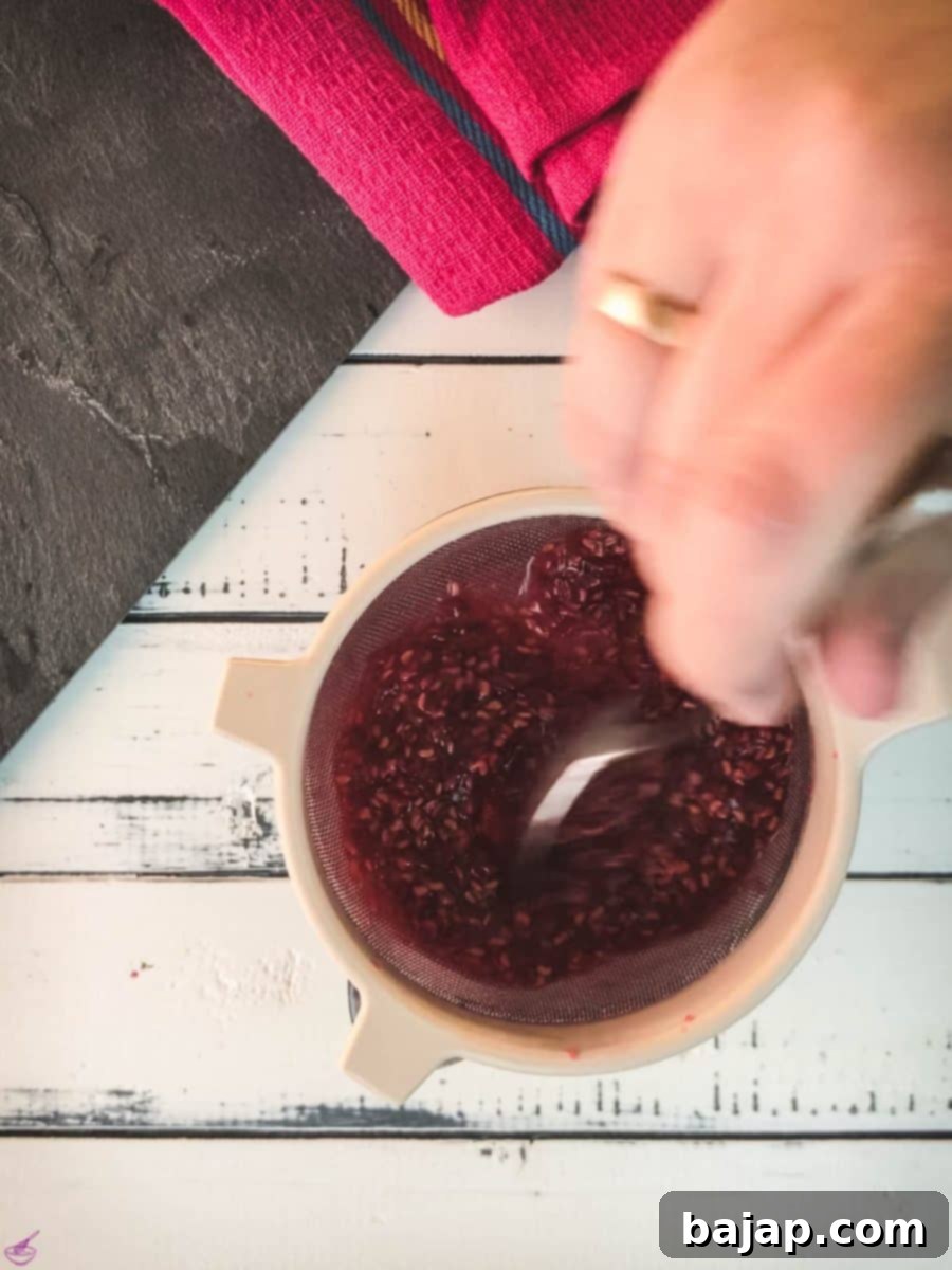 Pass the raspberry mixture through a sieve using a spoon.