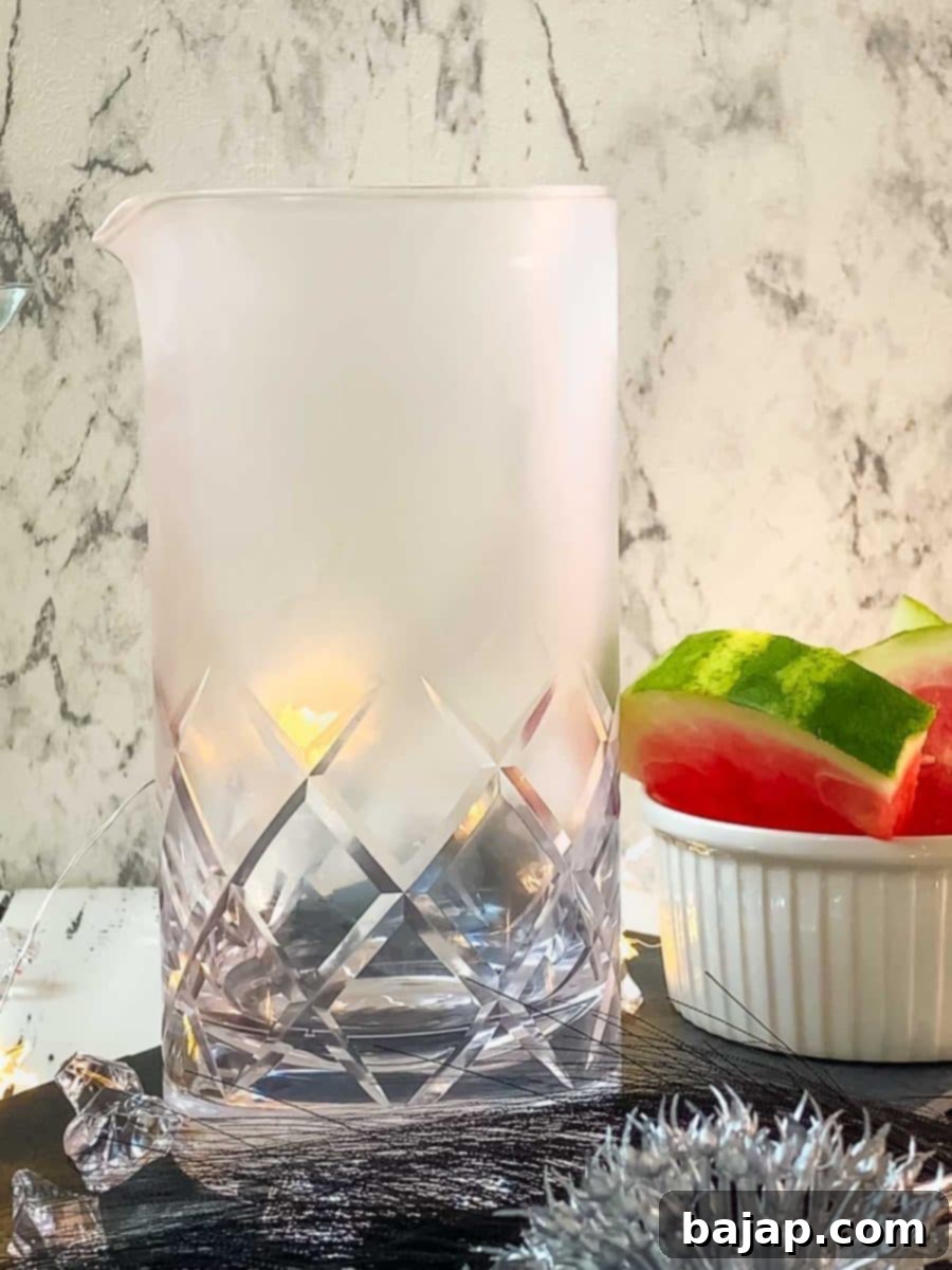 Place the chilled stirring glass on the table, preparing for cocktail mixing.