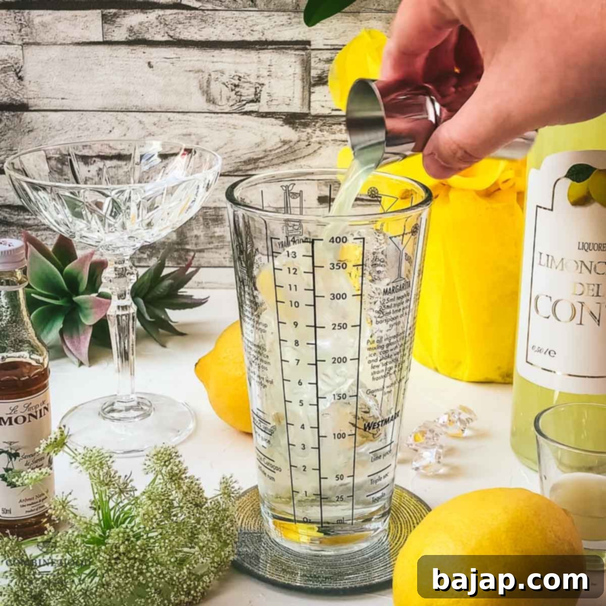 A vibrant yellow liquid, Limoncello, being poured into the cocktail shaker, ready to infuse its zesty flavor.