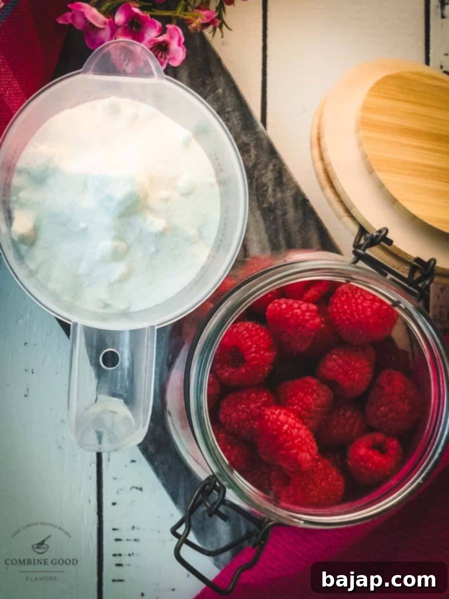 Ingredients for uncooked raspberry syrup - granulated sugar and fresh raspberries.