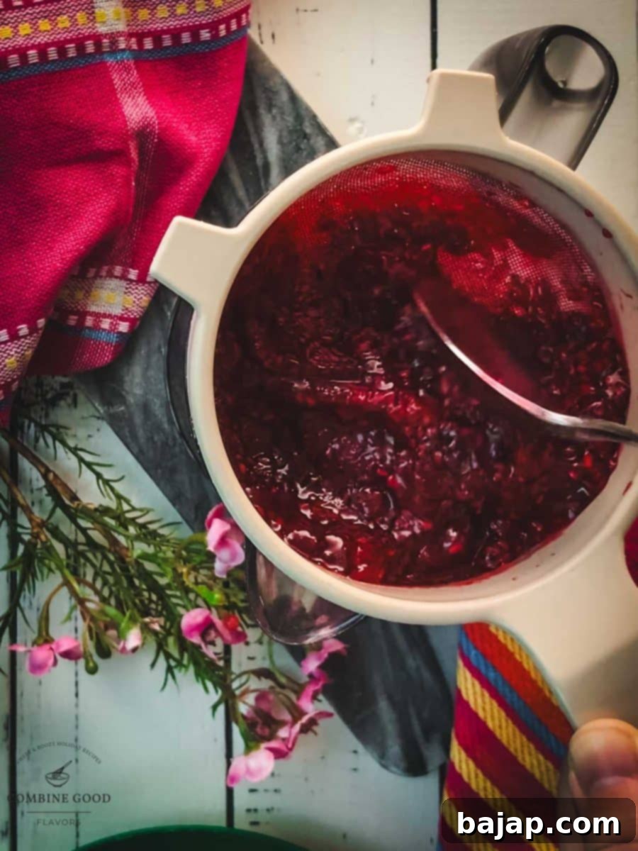 Pass the raspberry sauce through a fine-mesh sieve .