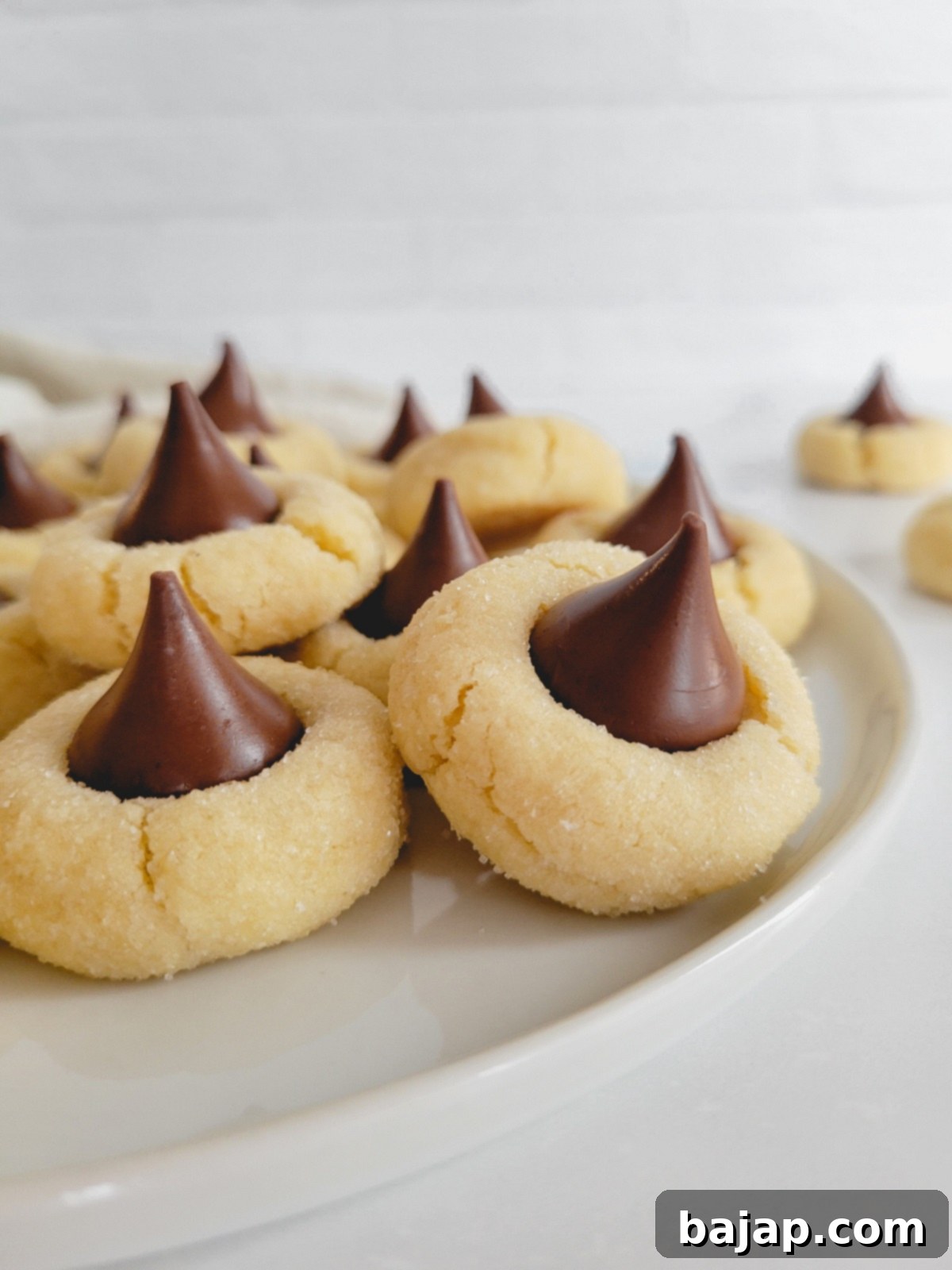 Soft and chewy sugar cookies topped with melty Hershey Kisses.