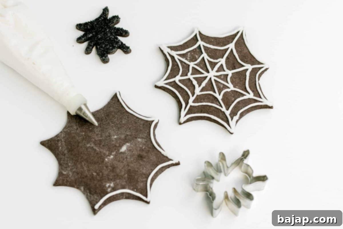 Dark, rich black cocoa chocolate sugar cookies with vibrant orange frosting for Halloween.