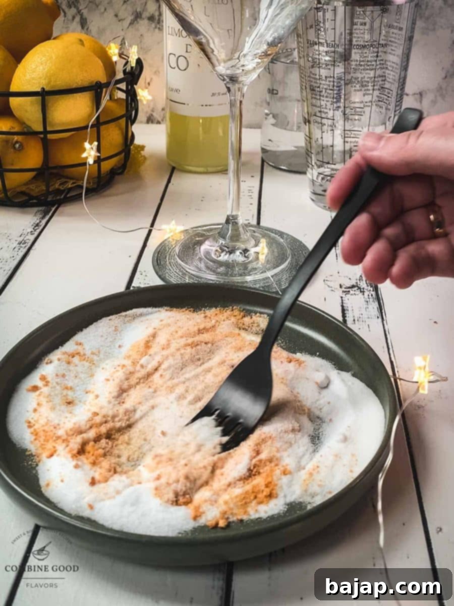 Using a fork, combine fine granulated sugar with organic orange zest on a plate.
