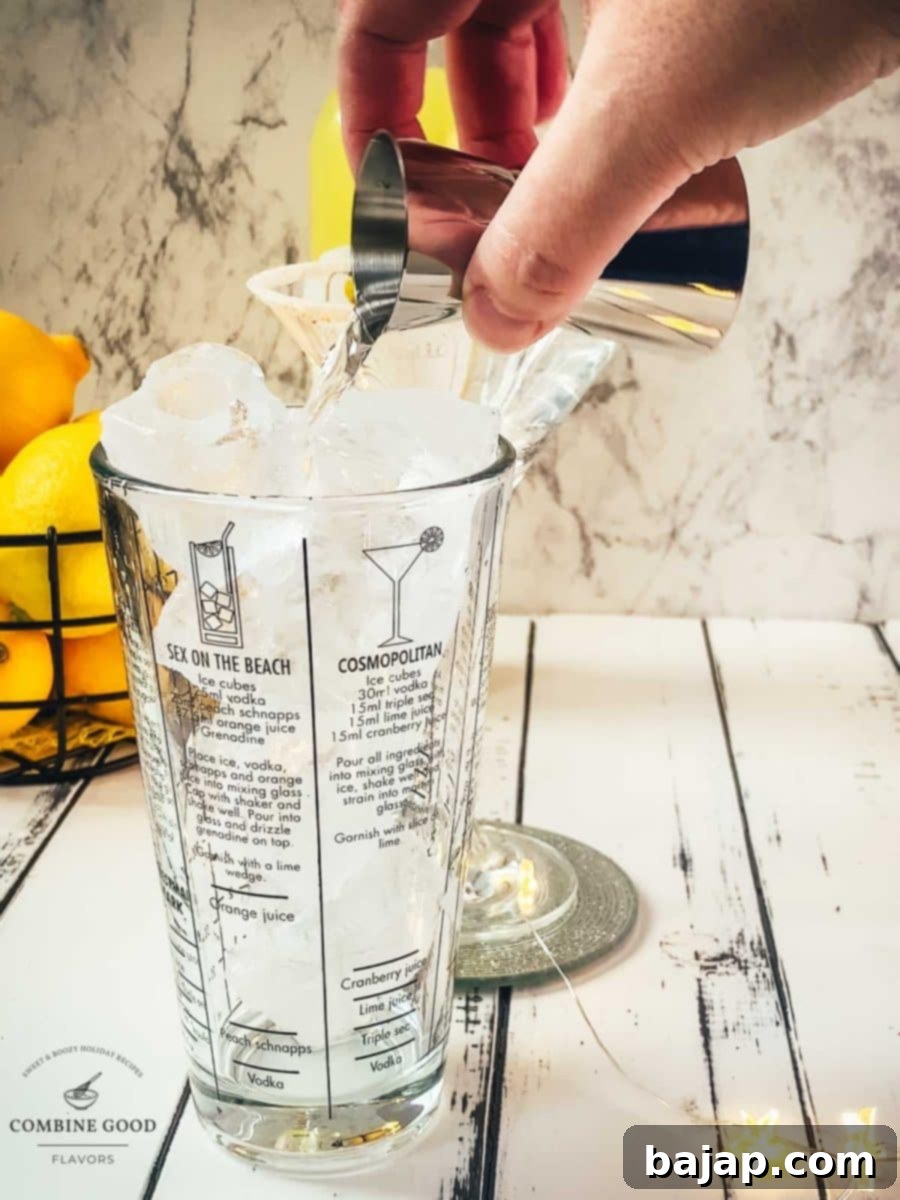 Adding the vodka to the cocktail shaker.