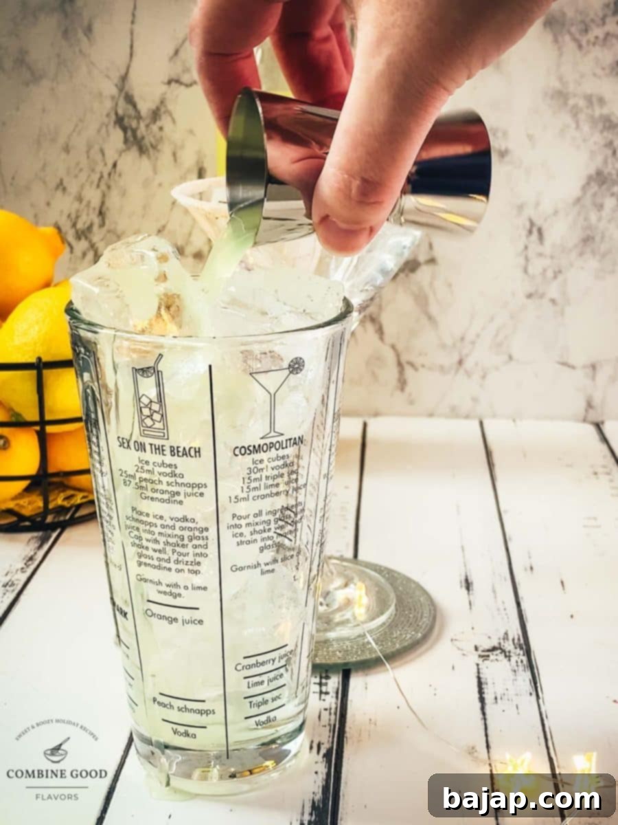 Adding the Limoncello to the cocktail shaker.