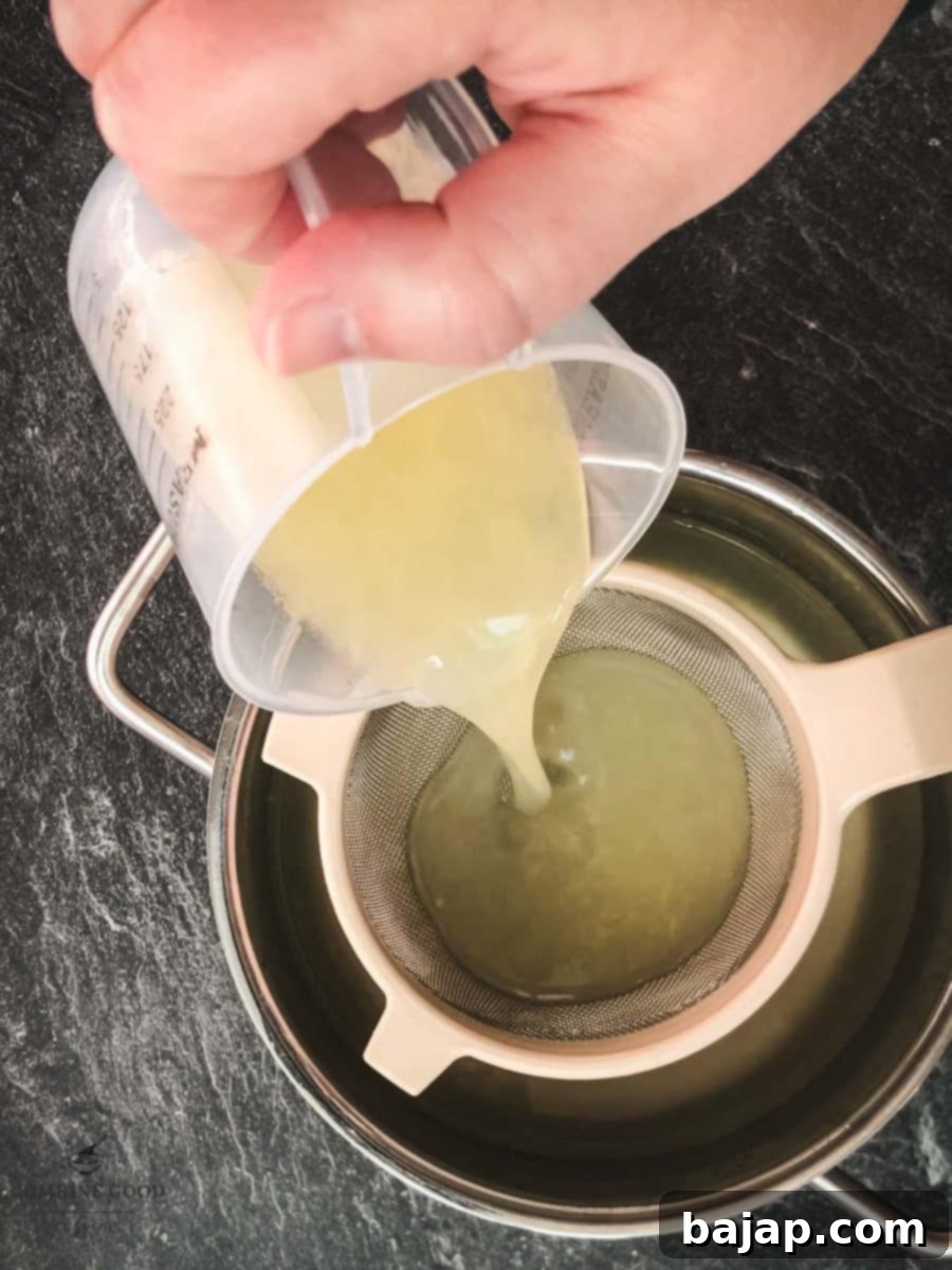Strain the lemon juice into the saucepan.