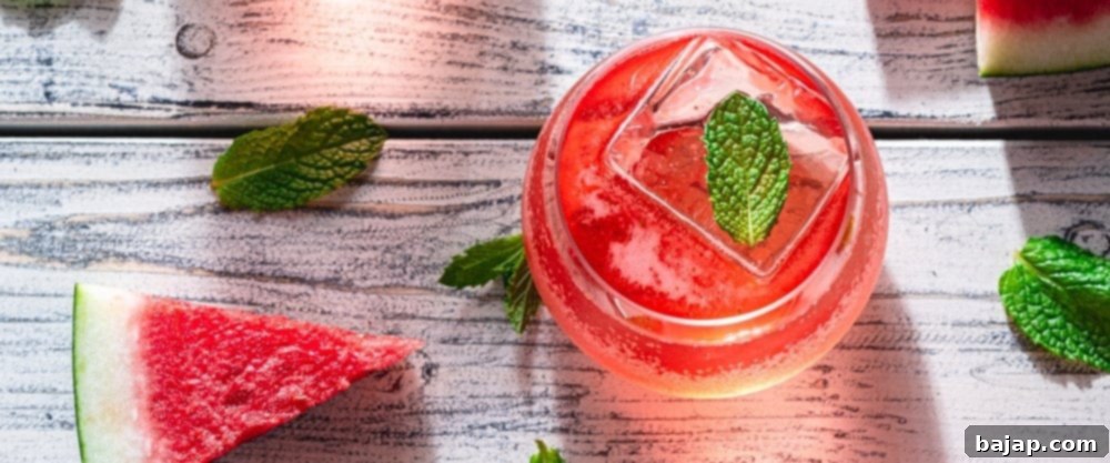A beautiful Watermelon Dreams Cocktail, featuring a red hue and a garnish, served in a elegant glass.