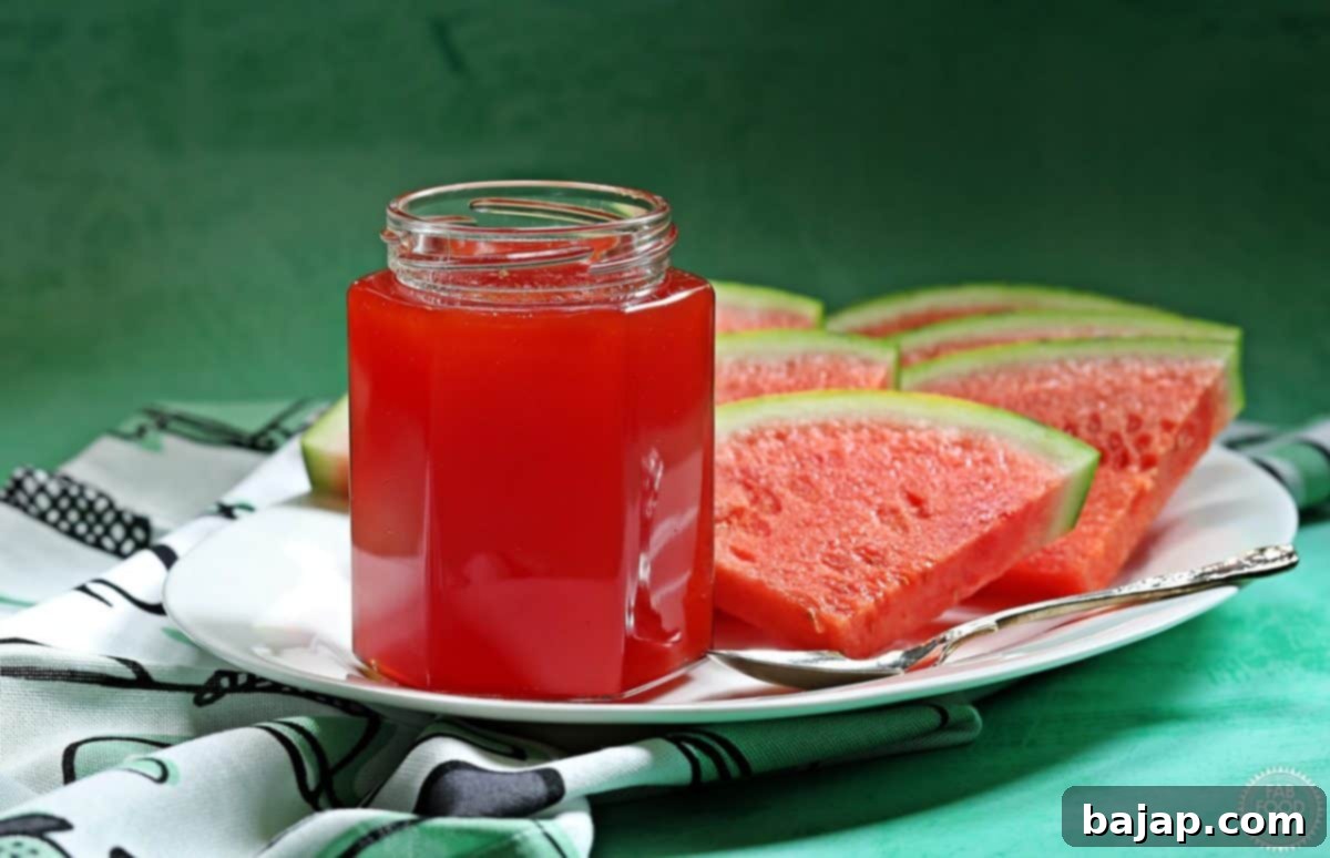 Jars of homemade watermelon jam, showcasing its beautiful vibrant pink color, with fresh watermelon pieces.