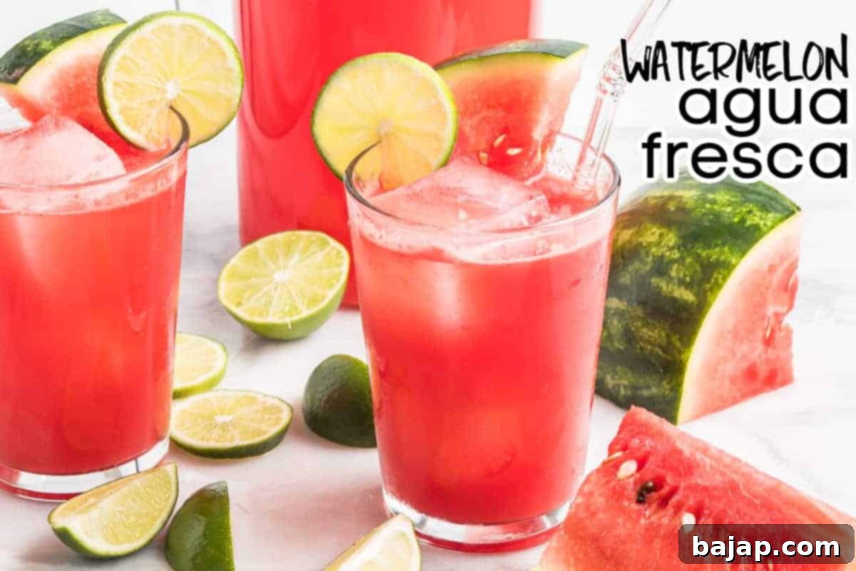 A glass of refreshing Watermelon Agua Fresca, garnished with a lime slice and mint, against a light background.