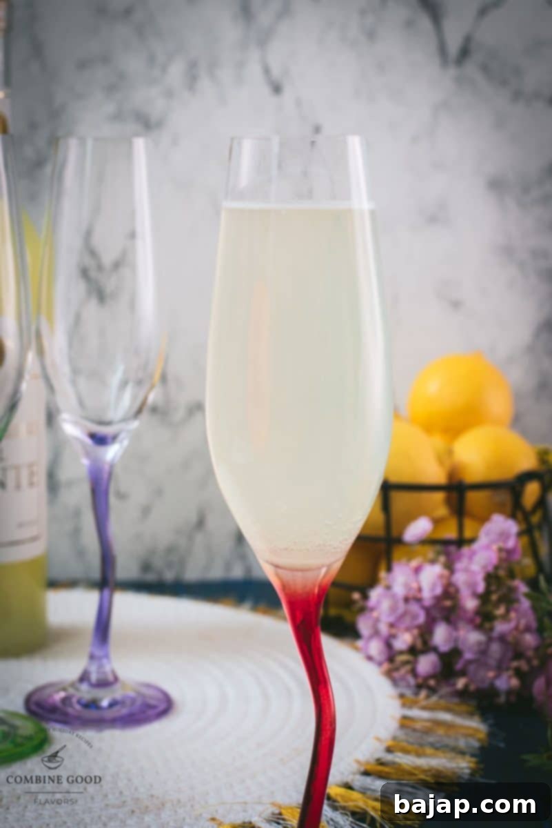 Gorgeous champagne glass filled with delicious sparkling limoncello, garnished with a lemon slice, ready to be enjoyed on a warm day.