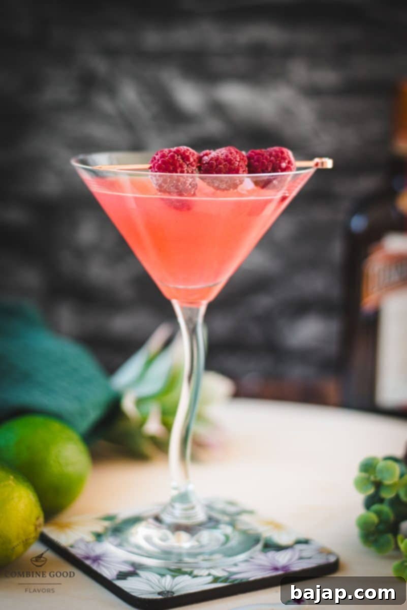 A stunning raspberry margarita, perfectly composed in a cocktail glass with fresh raspberry garnish, promising a delightful drinking experience.