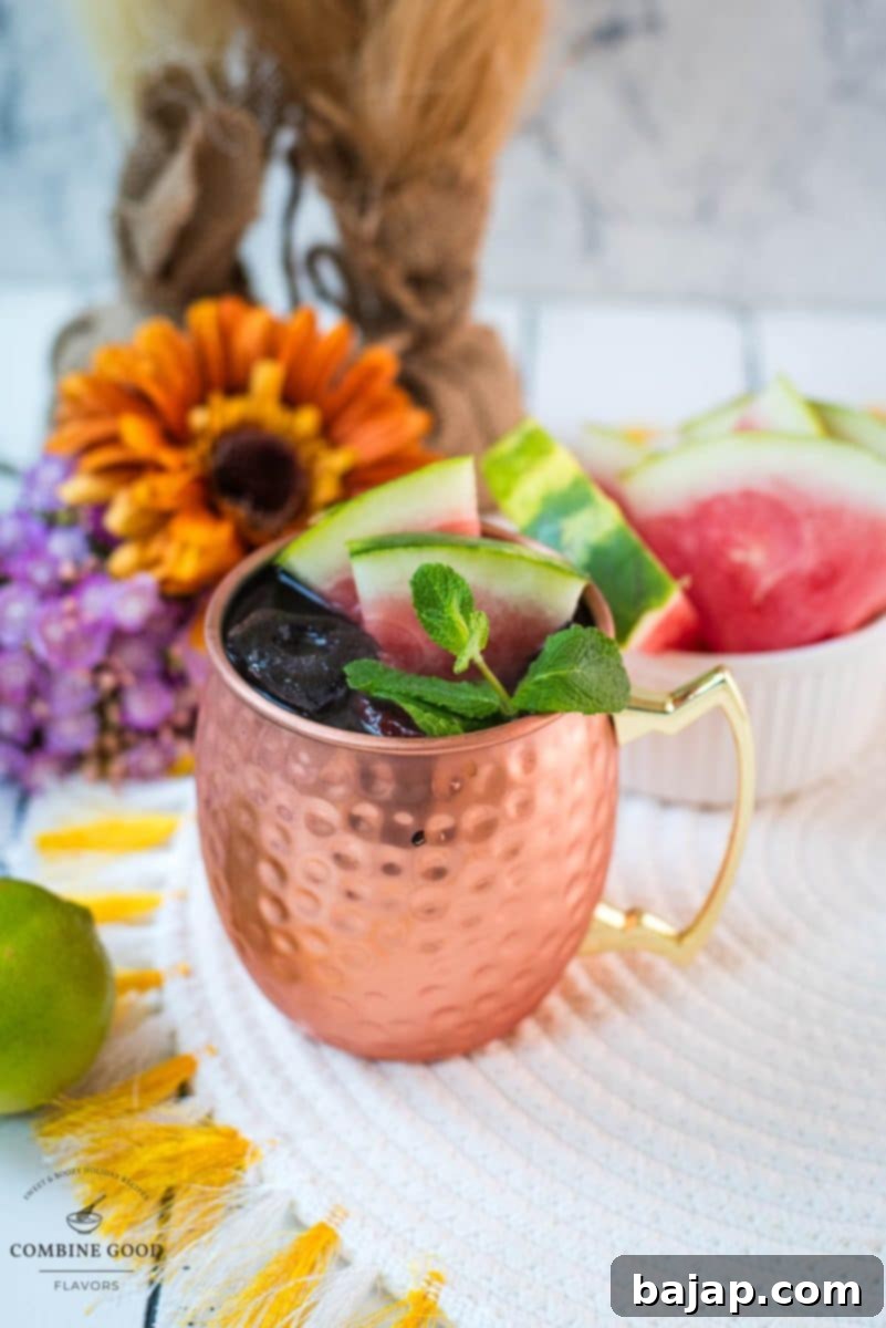 A stunning Watermelon Moscow Mule in a gleaming copper mug, artfully garnished with watermelon and mint, glistening with condensation, ready to be enjoyed.