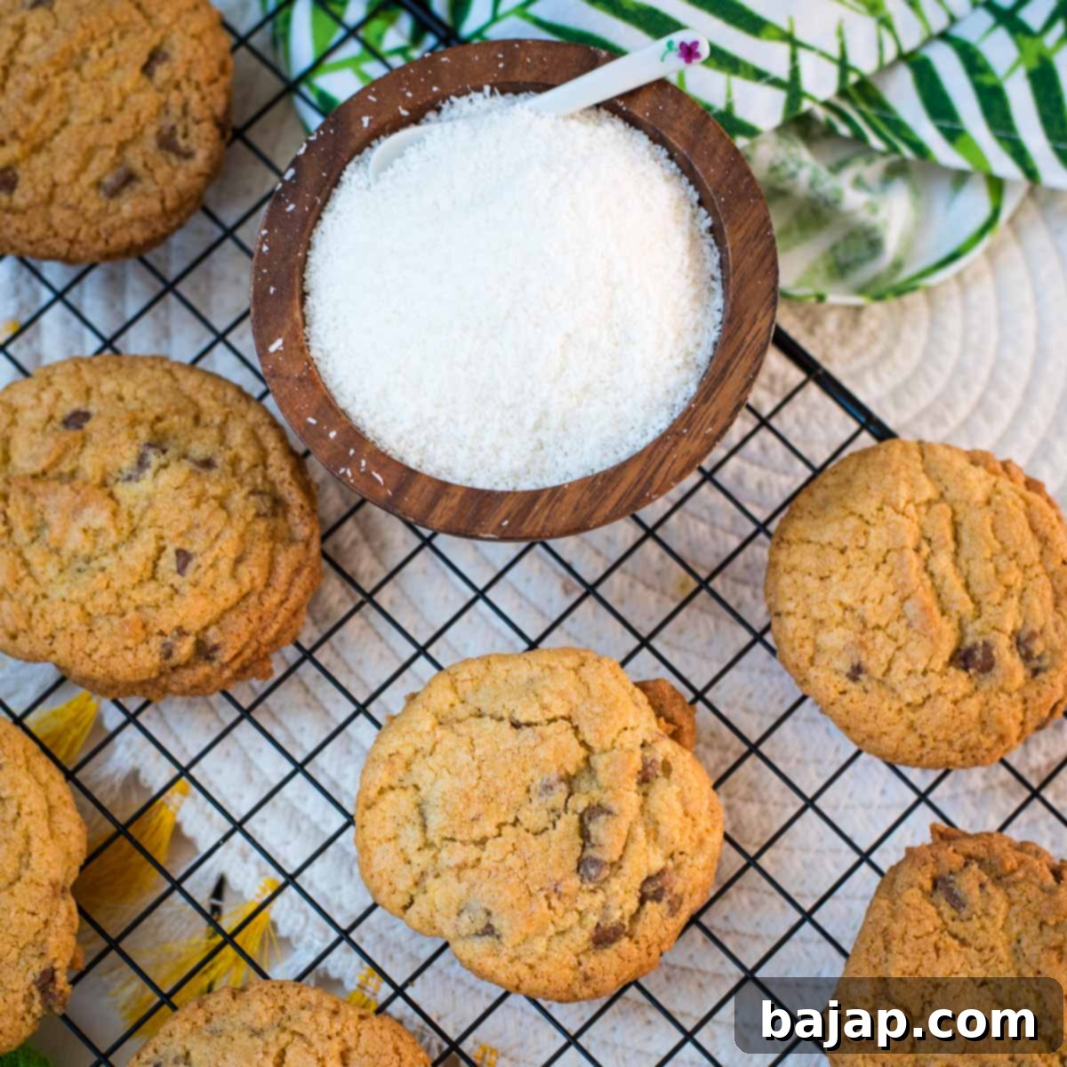 Delicious coconut chocolate chip cookies, on a cooling rack.