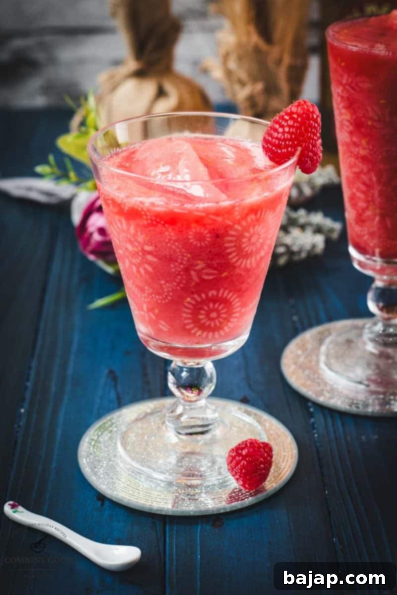 Raspberry Chill Margarita 14 A close-up of a beautifully garnished frozen raspberry margarita, showcasing its vibrant color and frosty texture, ready for a refreshing sip.