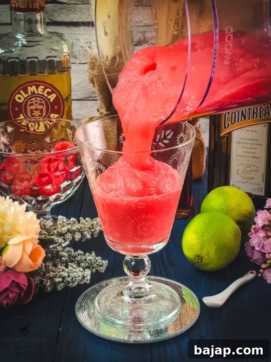 Raspberry Chill Margarita 10 Pouring the freshly blended frozen raspberry margarita into elegant chilled cocktail glasses, ready for serving.