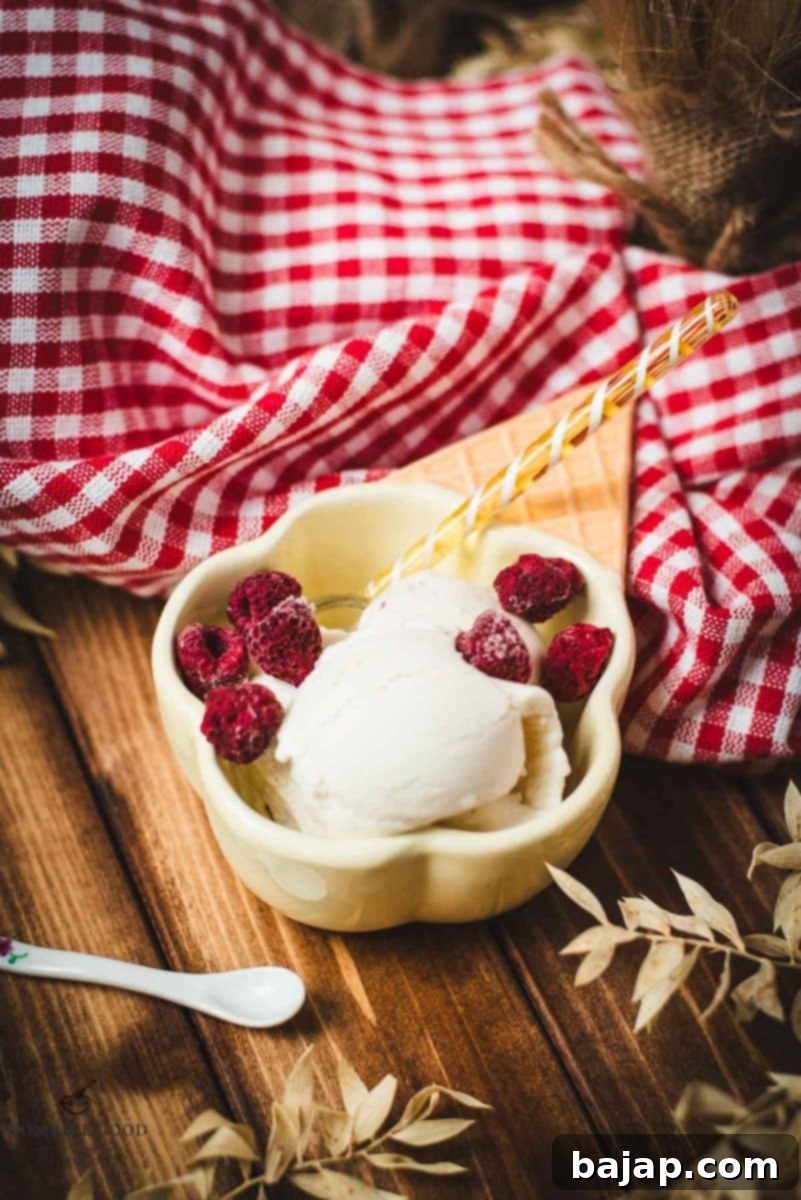 Delightful serving bowl filled with sour cream ice cream that looks like an ice cream cone with ice cream scoops. Placed on a brown wooden background.
