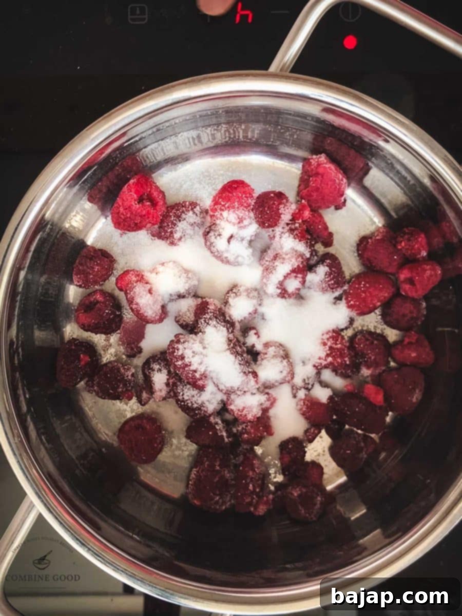Combine sugar and raspberries in a saucepan.