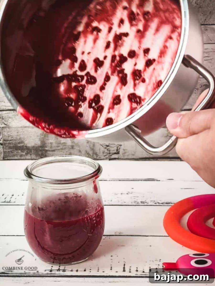 Pour the raspberry sauce into a preserving jar.