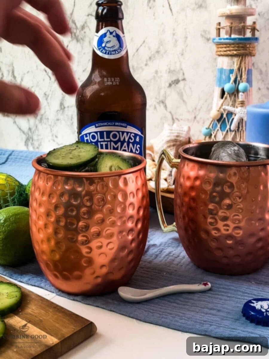 Garnishing a Cucumber Moscow Mule with marinated cucumber slices on top, enhancing both presentation and flavor.