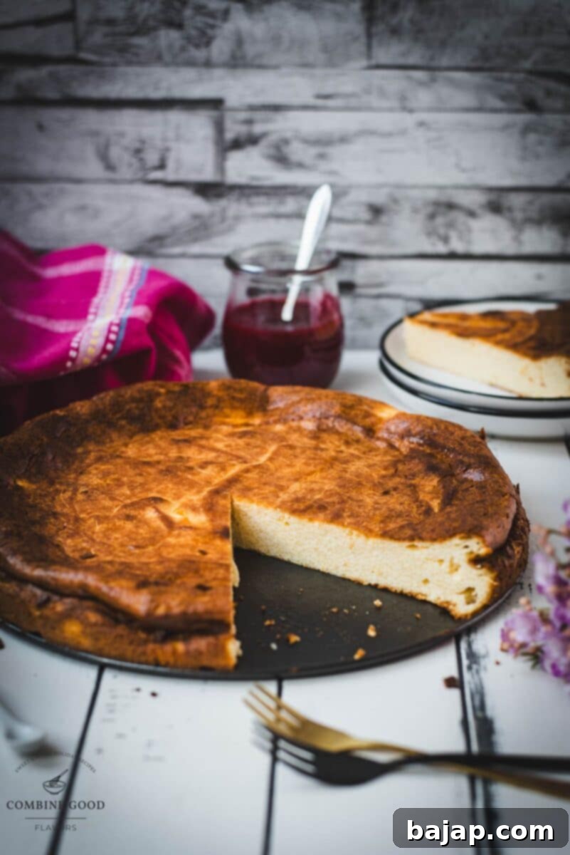Freshly baked semolina cheesecake cooling on a wire rack, still in its springform pan, showing its perfectly golden-brown top and slightly risen edges.